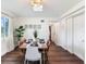 Inviting dining room with wood floors, modern chandelier, natural light and decorative wall art at 1243 55Th N Ave, St Petersburg, FL 33703