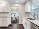Bright kitchen boasts white cabinetry, marble countertops, stainless steel sink, and dining area access at 1243 55Th N Ave, St Petersburg, FL 33703