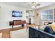 Stylish living room showcasing hardwood floors, a flat screen TV, a view into the kitchen, and modern decor at 1243 55Th N Ave, St Petersburg, FL 33703