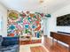Vibrant living space featuring a hand-painted mural, and a view into another room beyond at 1243 55Th N Ave, St Petersburg, FL 33703