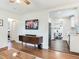 Open concept living room with a view into other rooms; hardwood floors, updated light fixtures, and modern decor at 1243 55Th N Ave, St Petersburg, FL 33703