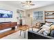 Inviting living room featuring hardwood floors, modern furnishings, a view of the kitchen, and a ceiling fan at 1243 55Th N Ave, St Petersburg, FL 33703