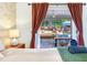 Relaxing main bedroom showing a partial view of the pool and patio through curtains, enhancing indoor-outdoor living at 1243 55Th N Ave, St Petersburg, FL 33703