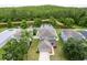 Aerial view shows a charming home with a pond view and manicured lawn at 12624 White Bluff Rd, Hudson, FL 34669