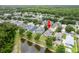 Drone shot featuring the home's backyard, pond, and surrounding neighborhood at 12624 White Bluff Rd, Hudson, FL 34669
