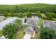 Aerial view captures the home's proximity to a beautiful pond and lush greenery at 12624 White Bluff Rd, Hudson, FL 34669
