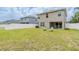 Expansive backyard featuring a pristine white fence, green lawn, and house exterior at 12624 White Bluff Rd, Hudson, FL 34669