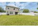Well-maintained backyard with a white fence, lush grass, and an outdoor patio at 12624 White Bluff Rd, Hudson, FL 34669