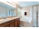 Well-appointed bathroom with double sinks, a soaking tub, and a separate glass-enclosed shower at 12624 White Bluff Rd, Hudson, FL 34669