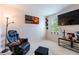 Versatile room with a gaming chair and large screen TV, ideal for a home office or entertainment space at 12624 White Bluff Rd, Hudson, FL 34669