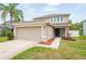 Charming two-story home with a well-maintained lawn and attached two car garage at 12624 White Bluff Rd, Hudson, FL 34669