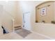 Inviting foyer with tile flooring, staircase, and decorative accents at 12624 White Bluff Rd, Hudson, FL 34669