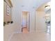 Open-concept entry with tiled floor leading to the half-bathroom and open archways at 12624 White Bluff Rd, Hudson, FL 34669