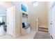 Spacious entryway featuring a hall tree and storage bench, adjacent to the carpeted stairs at 12624 White Bluff Rd, Hudson, FL 34669