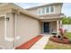 Close-up showcasing the home's front door, tidy yard, and well-kept landscaping at 12624 White Bluff Rd, Hudson, FL 34669
