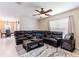 Comfortable living room with a cozy sectional sofa, ceiling fan, and dining room view at 12624 White Bluff Rd, Hudson, FL 34669