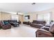 Spacious living room featuring comfortable leather seating and a stylish area rug at 12624 White Bluff Rd, Hudson, FL 34669