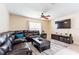 Spacious living room with a large leather sectional, mounted TV, and neutral decor at 12624 White Bluff Rd, Hudson, FL 34669