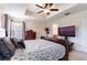 Serene primary bedroom featuring a large bed, a TV, a ceiling fan, and an en-suite bathroom entrance at 12624 White Bluff Rd, Hudson, FL 34669