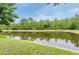 Scenic pond view showcases the tranquil landscape surrounding the property at 12624 White Bluff Rd, Hudson, FL 34669