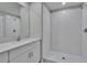 This bathroom offers a white vanity with quartz countertop and glass shower at 13187 Palmerston Rd, Riverview, FL 33579