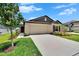 Inviting one-story home boasts a well-kept lawn, neutral siding, and a convenient two-car garage at 13187 Palmerston Rd, Riverview, FL 33579