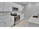 Well-equipped kitchen features stainless steel appliances, white cabinetry, and elegant quartz countertops at 13187 Palmerston Rd, Riverview, FL 33579