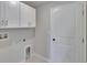 Functional laundry room with overhead cabinets and connections for a washer and dryer at 13187 Palmerston Rd, Riverview, FL 33579