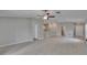 Open-concept living space with sleek tile flooring, recessed lighting, and seamless flow to the kitchen at 13187 Palmerston Rd, Riverview, FL 33579