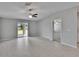 Spacious living area with sliding glass doors to backyard, neutral color palette, and tile flooring at 13187 Palmerston Rd, Riverview, FL 33579