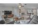 Modern living room with sleek furniture, a ceiling fan, and an open floor plan into the dining and kitchen areas at 13187 Palmerston Rd, Riverview, FL 33579