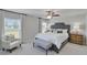 Cozy main bedroom features a ceiling fan, two windows, and tufted headboard at 13187 Palmerston Rd, Riverview, FL 33579