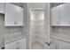 Spacious pantry with ample shelving for storage, complemented by white cabinets and light countertops at 13187 Palmerston Rd, Riverview, FL 33579