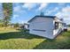Home with lawn and white stucco walls, featuring an outdoor space for leisure and recreation at 1415 Yale Dr, Holiday, FL 34691