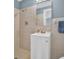 Bathroom featuring a vanity, shower with tile surround, and a mirrored medicine cabinet at 1415 Yale Dr, Holiday, FL 34691