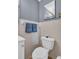 Bathroom featuring a toilet, tile wall, and a mirrored medicine cabinet at 1415 Yale Dr, Holiday, FL 34691