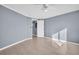 Spacious bedroom showcasing tile flooring and neutral walls, offering a versatile layout and access to other areas at 1415 Yale Dr, Holiday, FL 34691