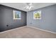 Bright bedroom with tile floors, ceiling fan, and neutral walls, offering a simple and clean aesthetic with natural light at 1415 Yale Dr, Holiday, FL 34691