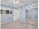 Bright bedroom featuring mirrored closet doors and a ceiling fan at 1415 Yale Dr, Holiday, FL 34691