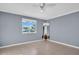 Open bedroom featuring tile floors, a ceiling fan, and neutral walls, perfect for creating a personalized living space at 1415 Yale Dr, Holiday, FL 34691