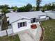 Aerial view of home with a new roof, manicured landscaping, and a charming walkway at 1415 Yale Dr, Holiday, FL 34691