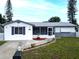 Inviting single-Gathering house with well-manicured landscaping and a cozy front porch at 1415 Yale Dr, Holiday, FL 34691