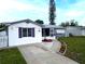 Charming single-story home with a well-maintained front yard and a welcoming entrance at 1415 Yale Dr, Holiday, FL 34691