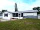 Charming home with a well-manicured lawn, walkway, and updated accents at 1415 Yale Dr, Holiday, FL 34691