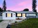 Charming single-story home with well-maintained landscaping and a welcoming entrance at 1415 Yale Dr, Holiday, FL 34691