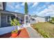 Charming home featuring a screened front porch, attractive landscaping, and a well-maintained walkway to the entrance at 1415 Yale Dr, Holiday, FL 34691