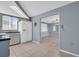 Kitchen open to a living area and featuring white appliances and tile flooring at 1415 Yale Dr, Holiday, FL 34691