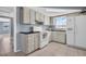 Functional kitchen with classic white appliances, light cabinets, and ample counter space at 1415 Yale Dr, Holiday, FL 34691