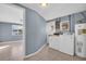 Functional laundry area with washer, dryer, and water heater, adjacent to a living space with access to natural light at 1415 Yale Dr, Holiday, FL 34691
