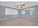 Inviting living room with neutral walls, tile floors, and a ceiling fan at 1415 Yale Dr, Holiday, FL 34691